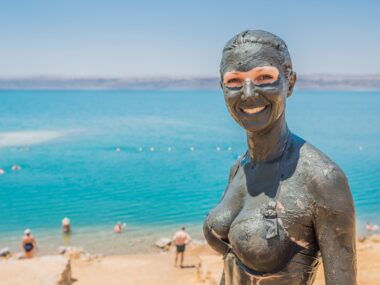 one caucasian woman applying dead sea mud body care treatment  in jordan