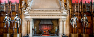 A fireplace and knight armor inside of Great Hall in Edinburgh Castle, Scotland