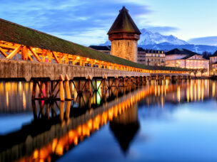 Wooden Chapel Bridge, Water Tower and Mount Pilatus in the Old Town of Lucerne, Switzerland, in the late evening light